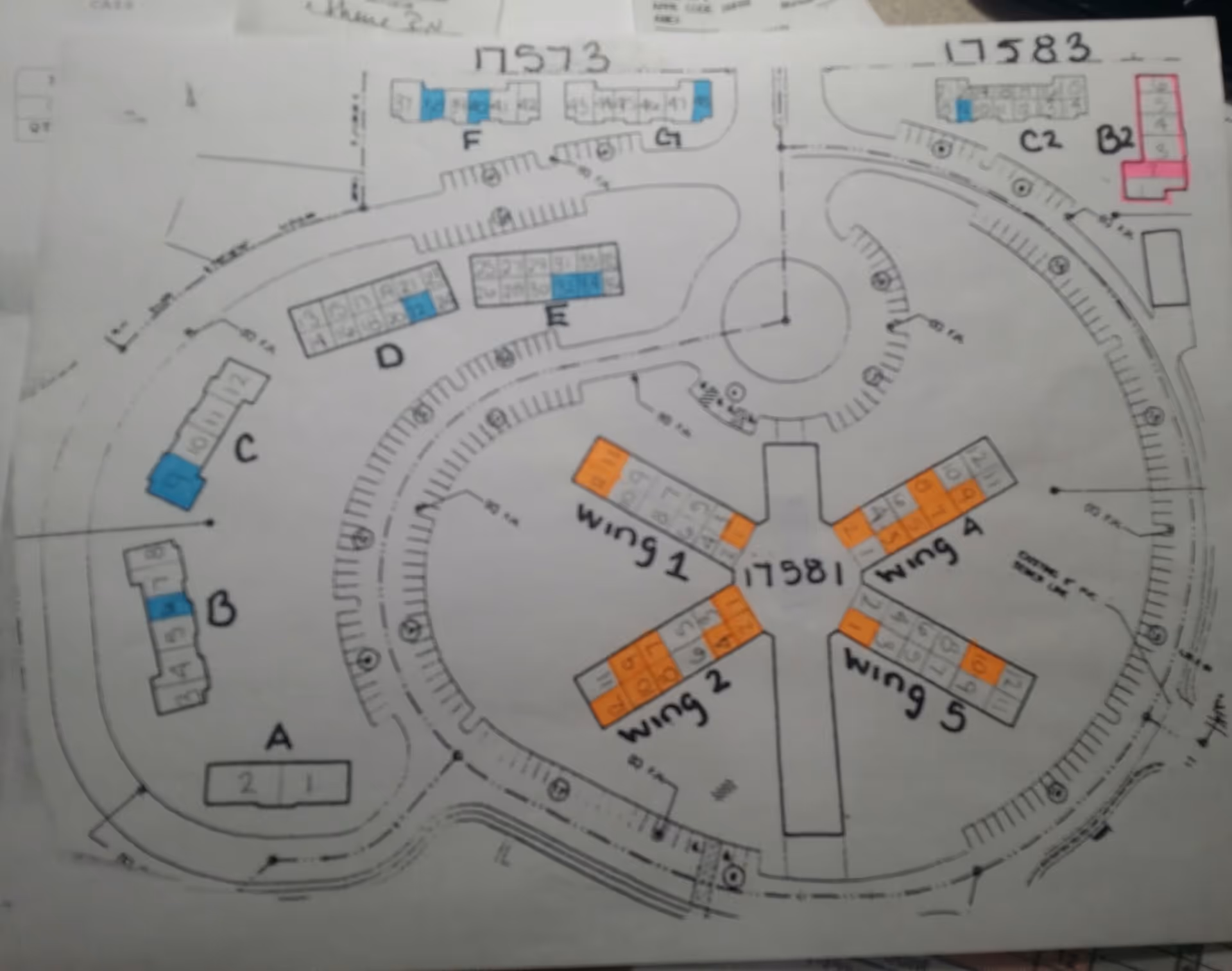 Architectural floor plan of Foremost Senior Campus showing multiple labeled wings and buildings arranged in a circular layout with color-coded sections in blue, orange, and pink.