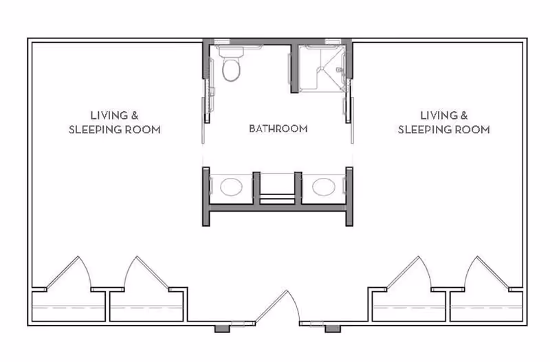 Architectural floor plan showing two living and sleeping rooms on either side of a central bathroom with two sinks, a toilet, and a shower.