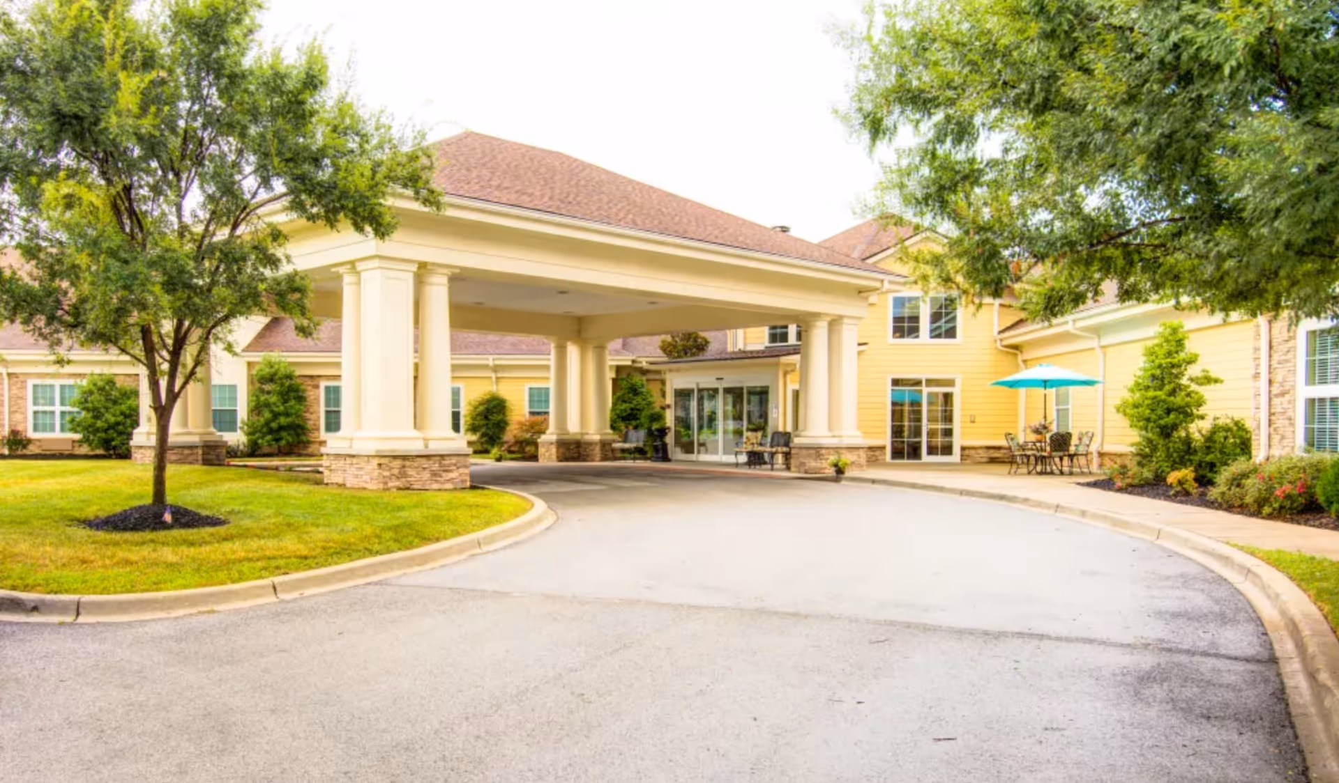 Front view of Symphony at Valley Farms with a covered entrance and outdoor seating.