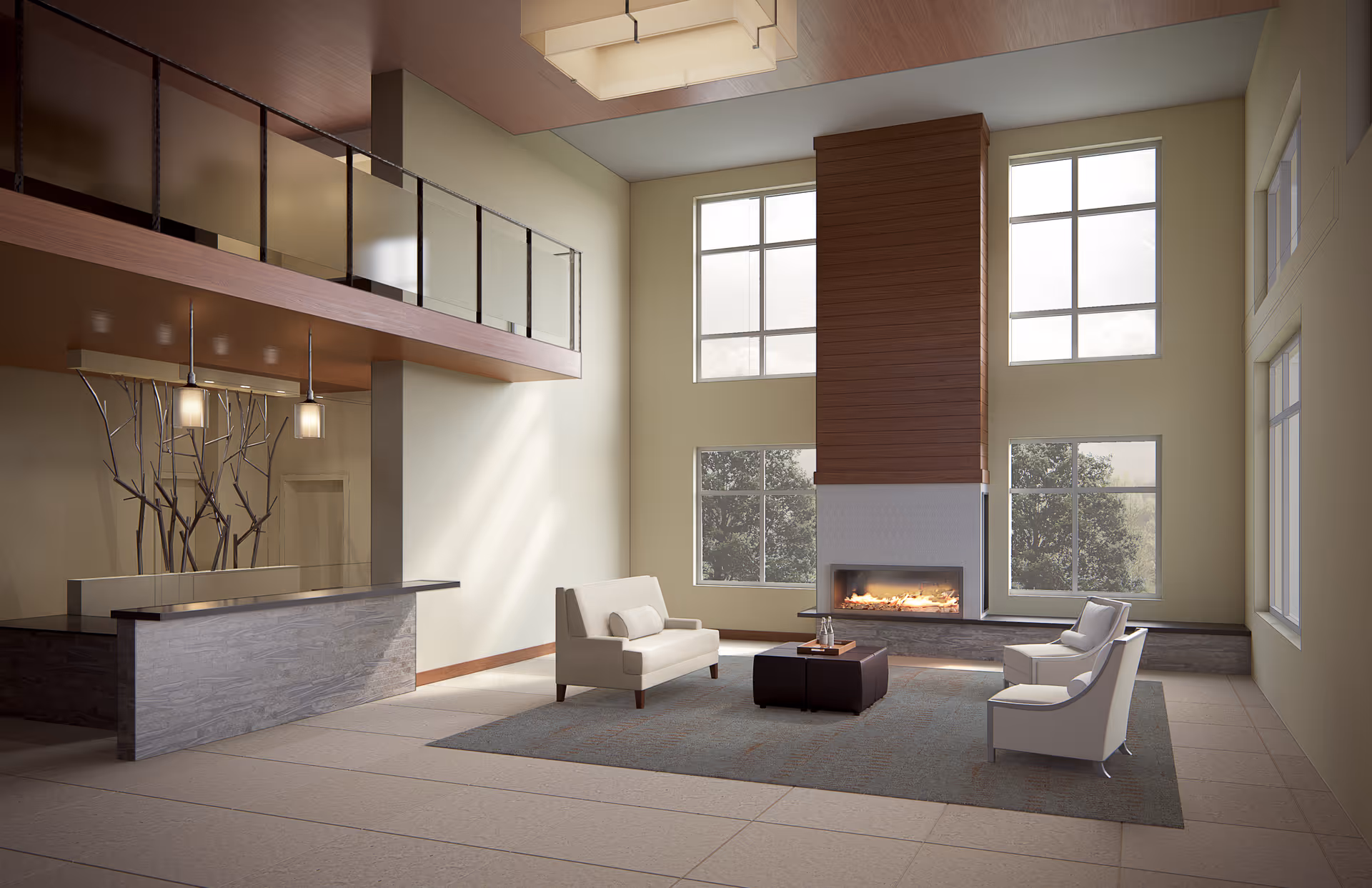 Spacious two-story lounge with a fireplace, seating area, reception desk, and mezzanine balcony.