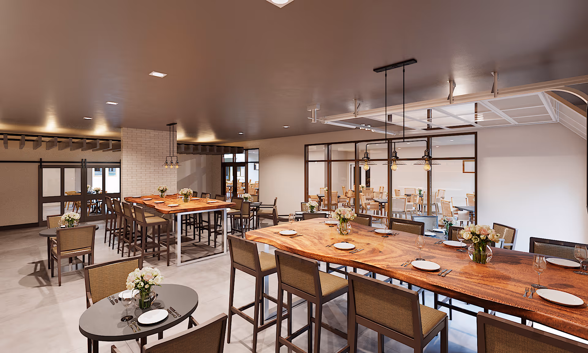 Spacious modern communal dining room with long live-edge wooden tables, place settings, chairs and floral centerpieces.
