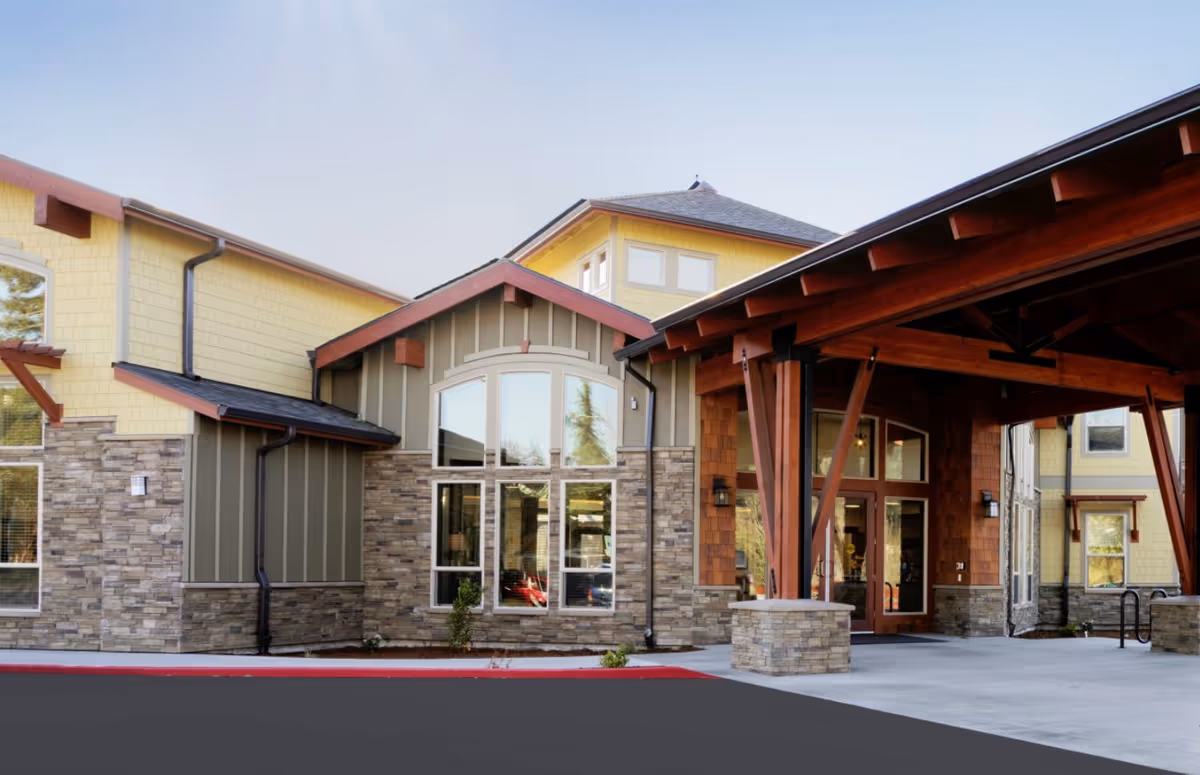 Exterior view of Mountain Park Memory Care entrance with stone accents and wooden canopy.