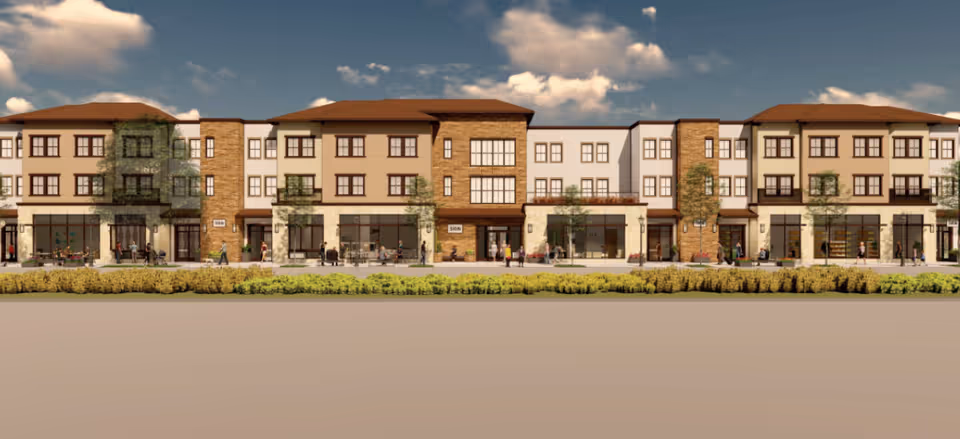 Exterior view of Villa Toscana Memory Care building with storefronts and landscaped front.