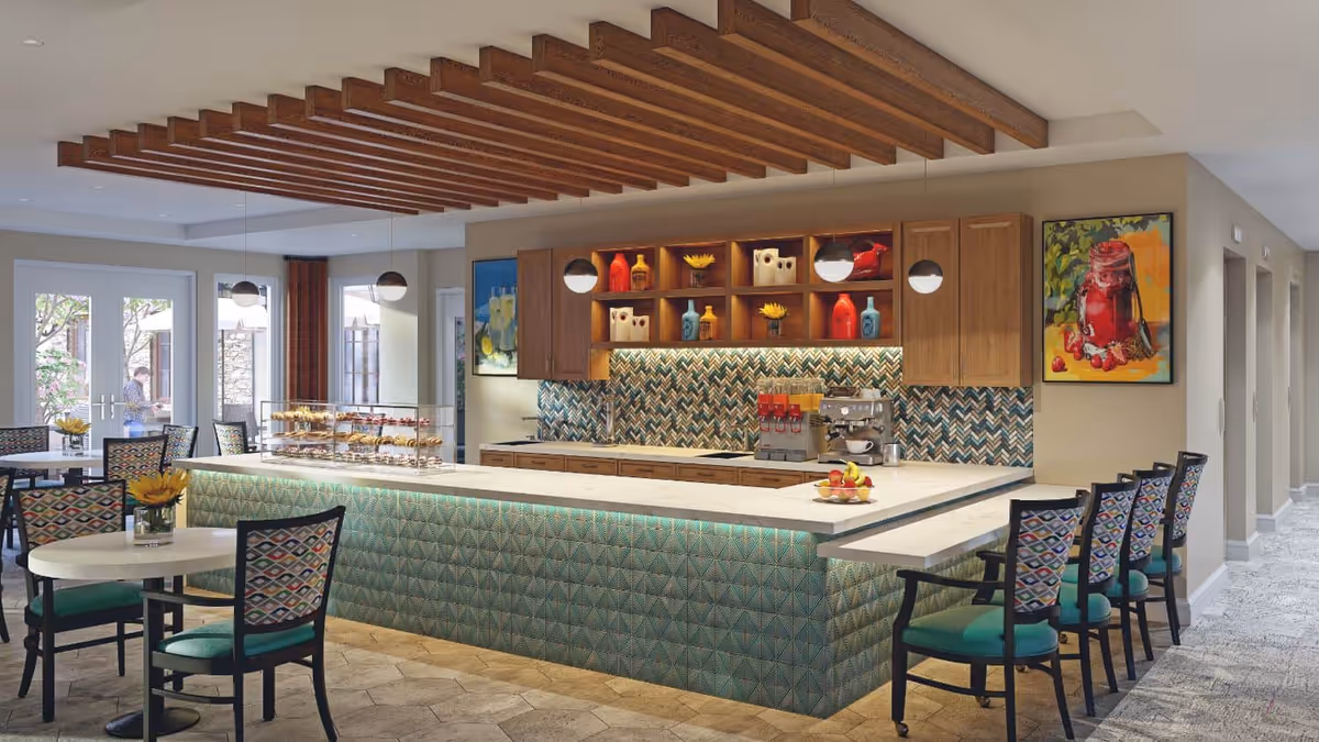 Modern communal dining area with a long tiled service counter, pendant lights, bar stools and small dining tables.
