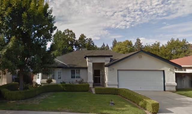 Front exterior of Christina's Care Home 1, a single-story house with a two-car garage.