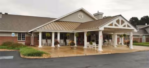 Exterior view of Brookdale Staunton's front entrance with white columns and seating.