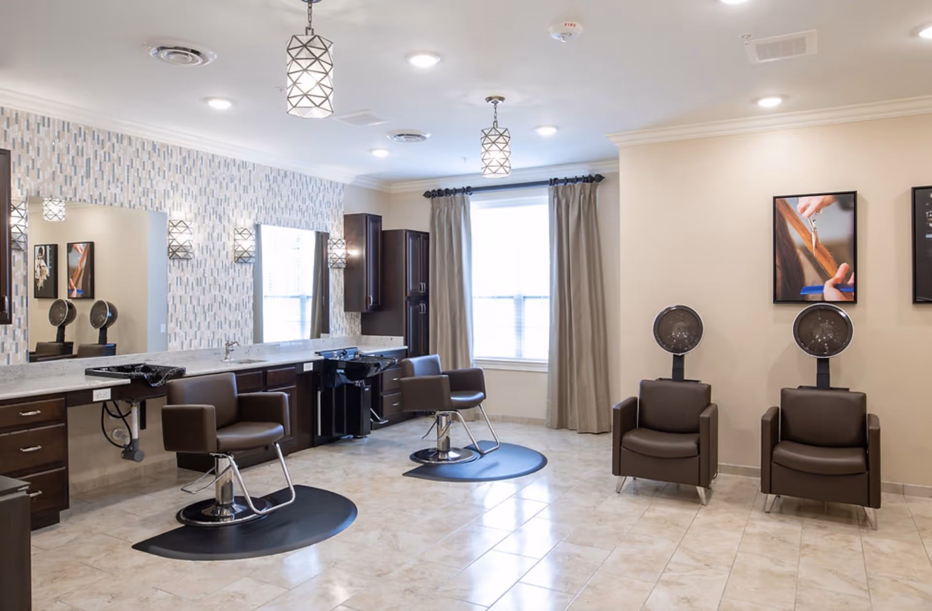 Bright, modern salon area with styling chairs, hooded hair dryers, mirrors, and cabinetry.