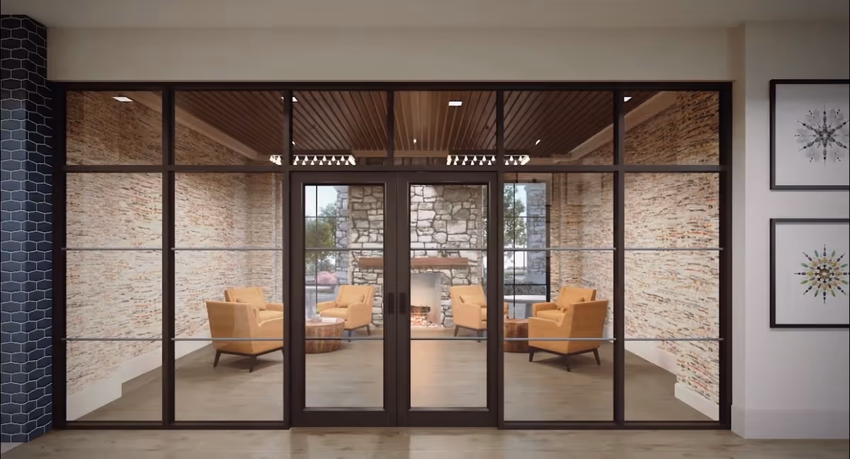 Glass-walled lounge with four mid-century armchairs and a fireplace seen through large interior glass doors.