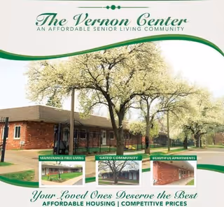 Exterior view of The Vernon Center senior living community showing a single-story brick building with large trees in bloom in front. The image includes text highlighting features such as maintenance-free living, gated community, and beautiful apartments.