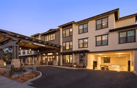 Exterior view of The Vincent senior living facility with a covered entrance and windows.