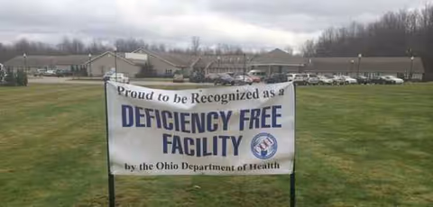 Banner on grass outside Saybrook Landing proclaims deficiency free facility.