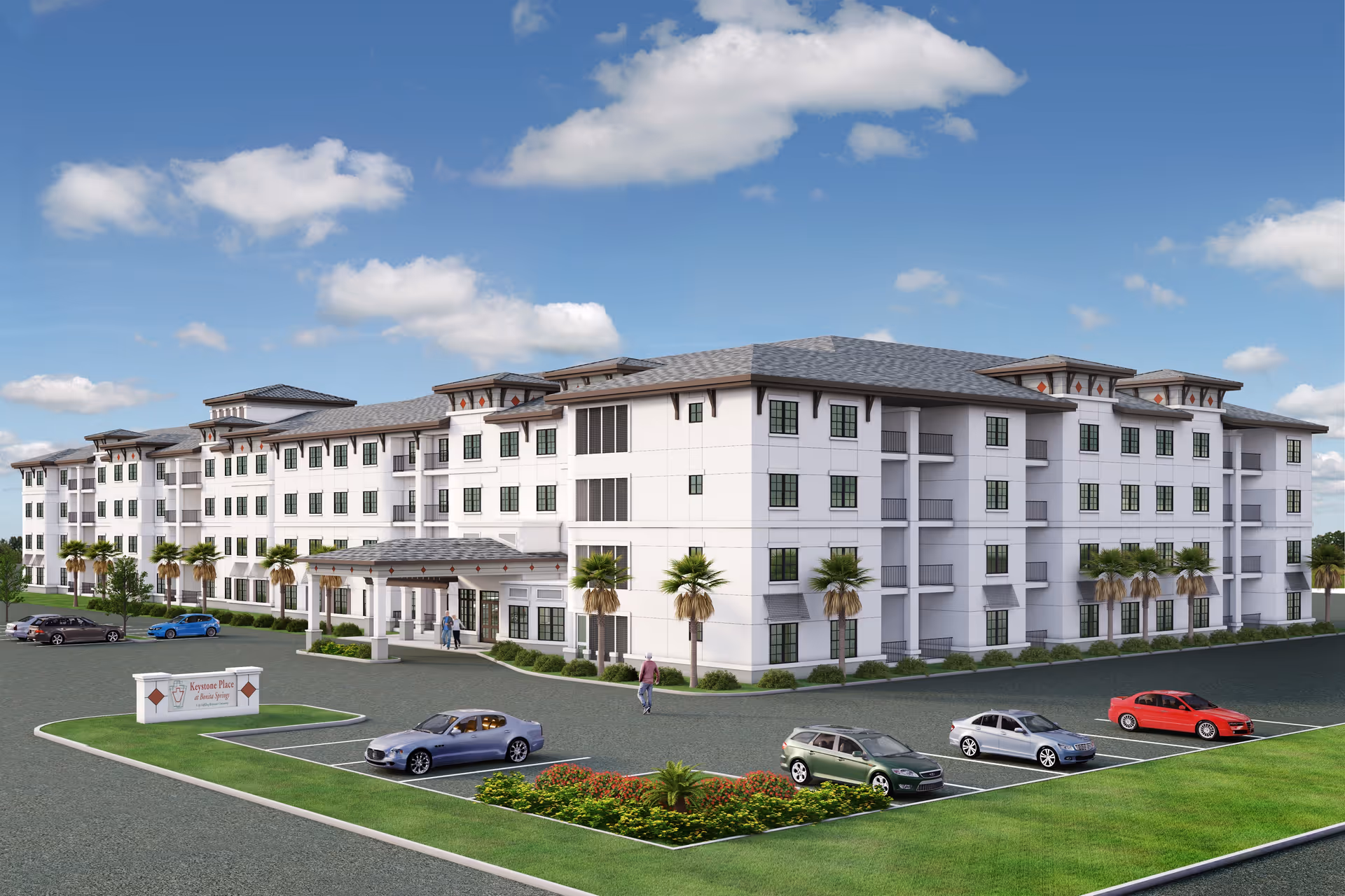 Exterior view of a large, modern four-story senior living facility building with multiple windows, palm trees, and a parking lot with several cars parked. The sky is blue with scattered clouds.
