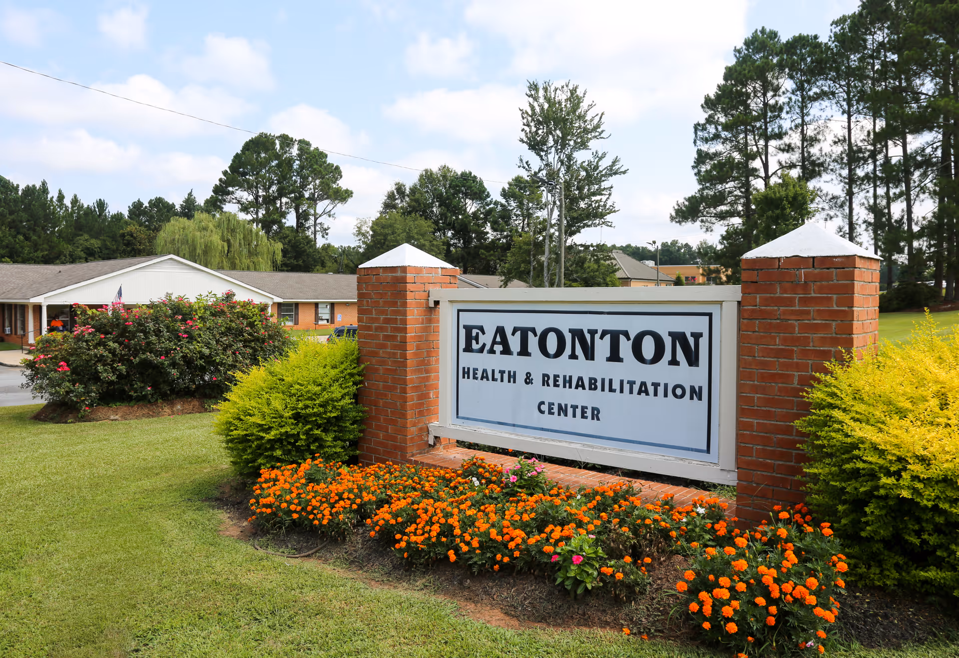 Entrance sign for Eatonton Health & Rehabilitation Center on a landscaped lawn in front of the facility.