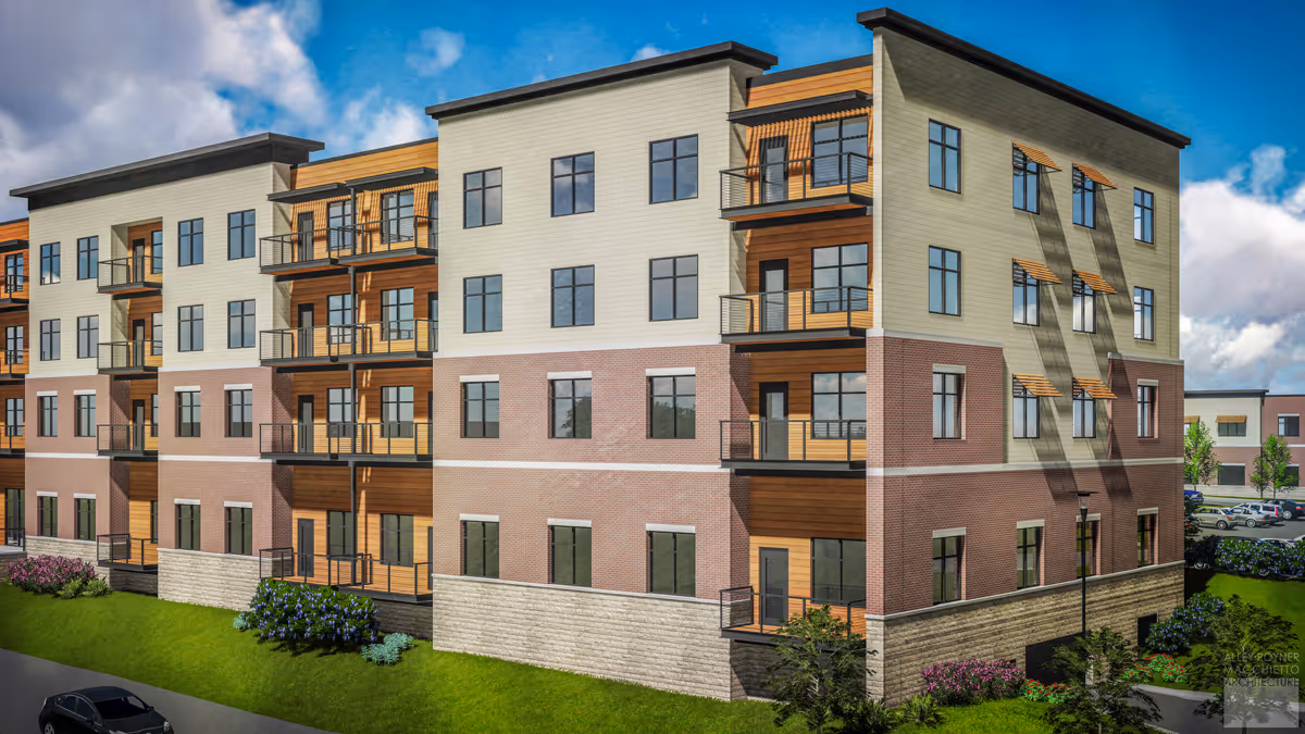 Exterior view of a modern four-story senior living facility building with balconies, large windows, and a mix of brick, wood, and light-colored siding. The building is surrounded by green grass, shrubs, and a parking lot with cars under a partly cloudy blue sky.
