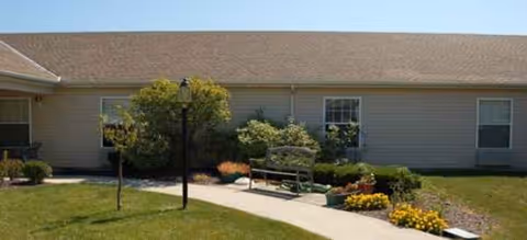 Front exterior of Brookdale Findlay, a single-story facility with a walkway and manicured landscaping.
