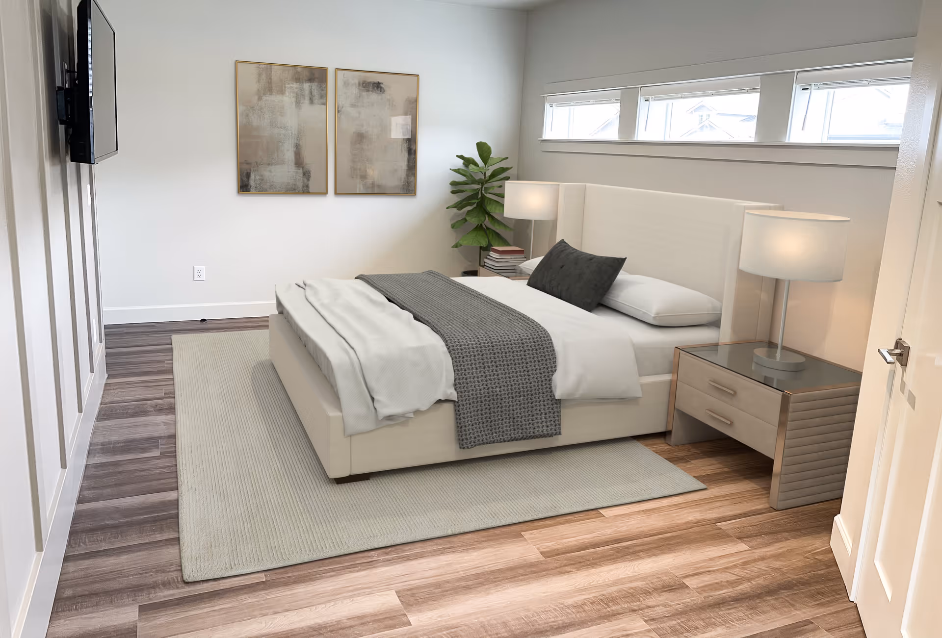 A modern bedroom with a large bed featuring white and gray bedding, two bedside tables with lamps, a potted plant in the corner, two abstract paintings on the wall, and a wall-mounted TV. The room has wooden flooring and a light-colored rug under the bed.