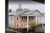 Exterior view of Schuykill Center building with brick accents and white trim.