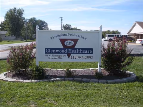 Glenwood Healthcare sign surrounded by landscaped flower beds outside the facility