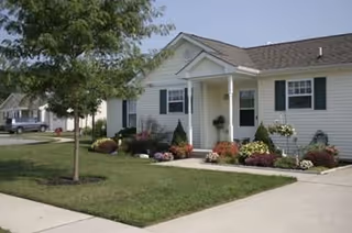 Single-story Friends Village facility with landscaped front yard and welcoming entrance.
