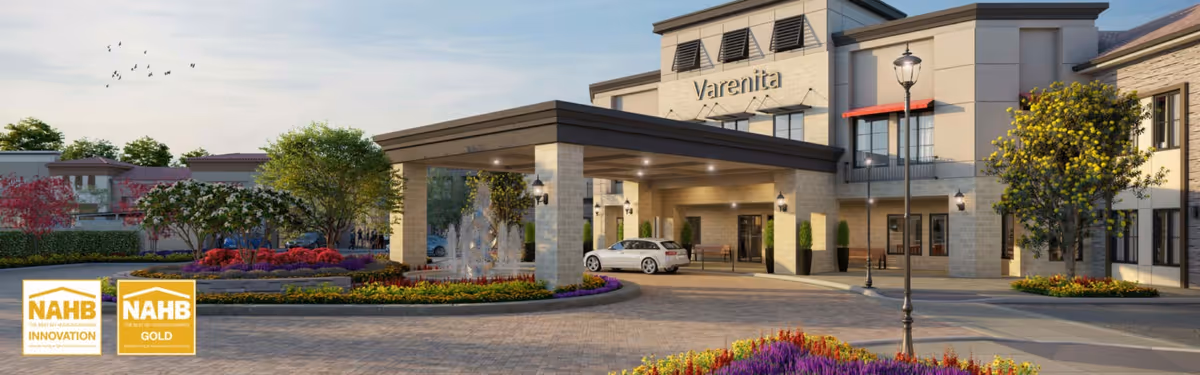 Front entrance of the Varenita Of Simi Valley senior living facility showing a porte-cochere, fountain, landscaping, and a parked car.