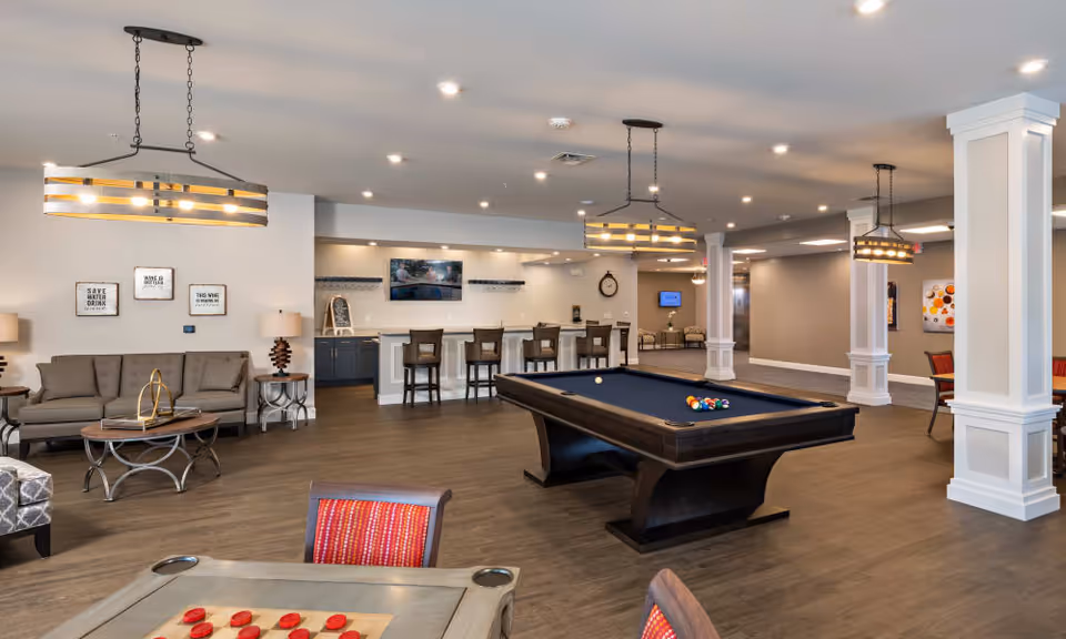 Indoor common area at Keystone Place at Richland Creek featuring pool table, seating, and bar.