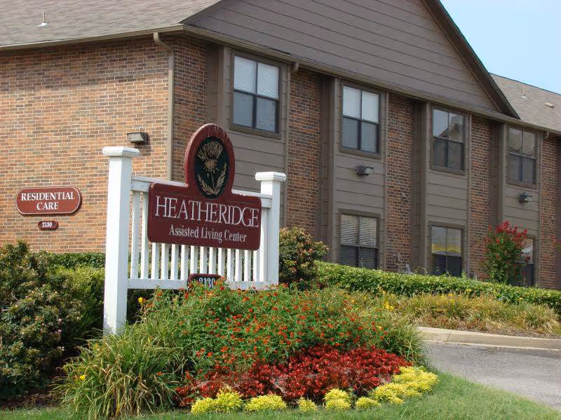Front exterior of Heatheridge Assisted Living Center with sign and landscaping.