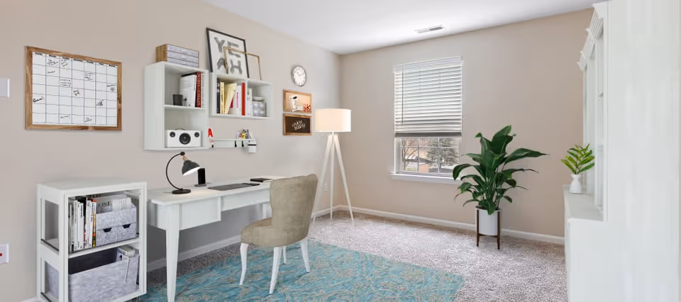 Bright, sparsely furnished interior room with a white desk and chair, wall shelving, floor lamp, potted plants, and a window.