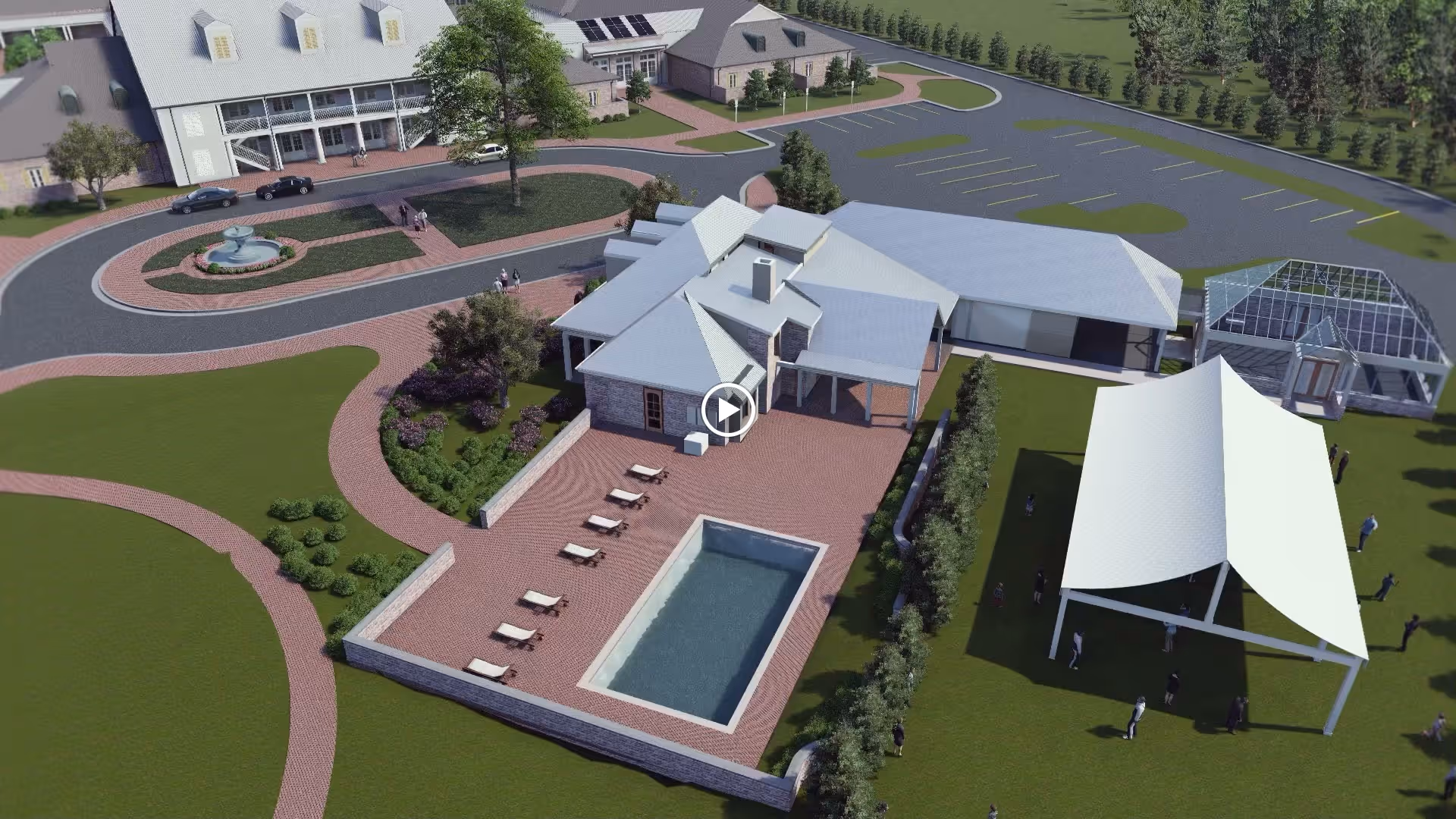 Aerial view of Gardens of Somerset facility showing a large building with a patio area featuring a rectangular swimming pool and several lounge chairs. Surrounding the building are landscaped gardens, a circular driveway with a fountain, a parking lot, a greenhouse, and a large white tent with people gathered underneath on a grassy area.