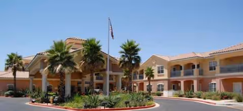 Exterior view of Brookdale North Scottsdale with palm trees and a circular driveway.