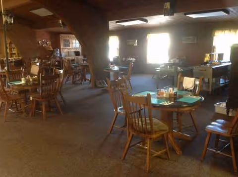 Interior dining room with wooden tables and chairs in a senior living facility