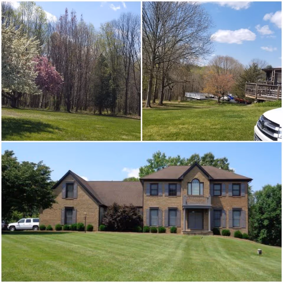 Collage of three images showing outdoor views of Joined Hands Assisted Living facility. The top left image shows a grassy area with trees, some with white and purple blossoms. The top right image shows a grassy area with leafless trees, a wooden deck, and parked cars in the distance. The bottom image shows the front exterior of a two-story brick building with multiple windows, a central entrance, and a well-maintained lawn with a white truck parked on the left side.