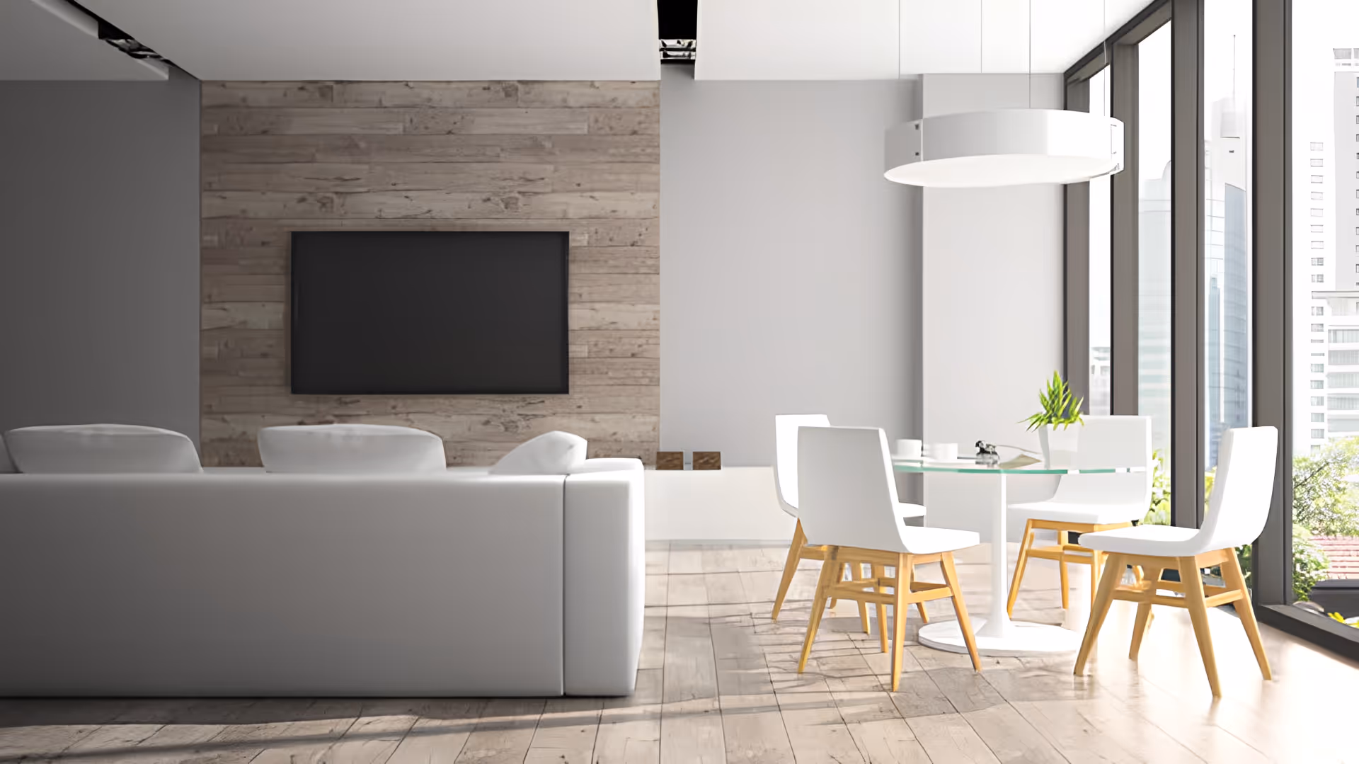 Modern open living and dining area with a white sofa, wall-mounted TV, glass dining table and large floor-to-ceiling windows.