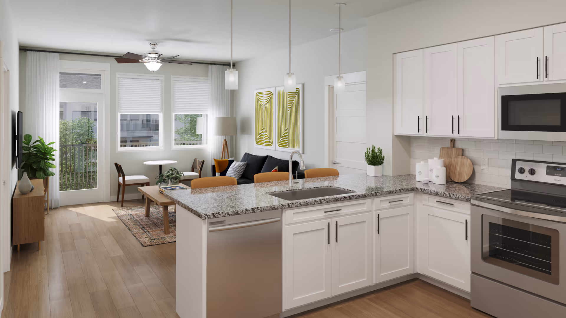 Modern open-concept living space featuring a kitchen with white cabinets, granite countertops, stainless steel appliances, and a sink island with three pendant lights above. Adjacent to the kitchen is a living area with a black sofa, a wooden coffee table, two chairs around a small round table, a floor lamp, and two abstract green and white wall art pieces. Large windows and a glass door lead to an outdoor balcony, allowing natural light to fill the room. The floor is light wood, and there is a ceiling fan with a light fixture.