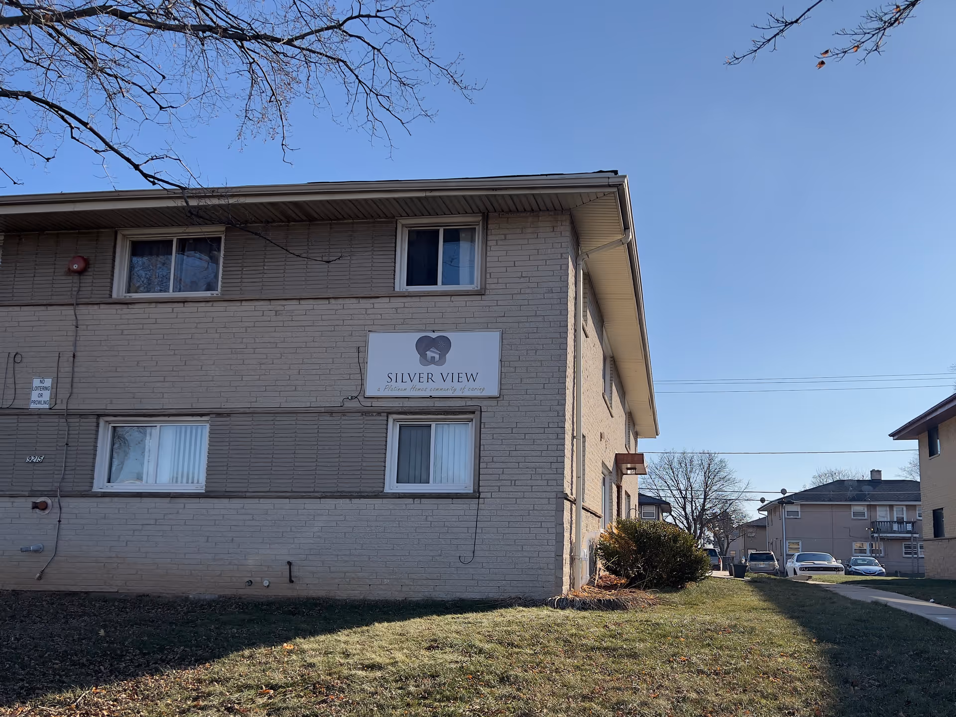 Exterior view of a two-story brick building with a 'Silver View' sign on the side and a grassy lawn in front.