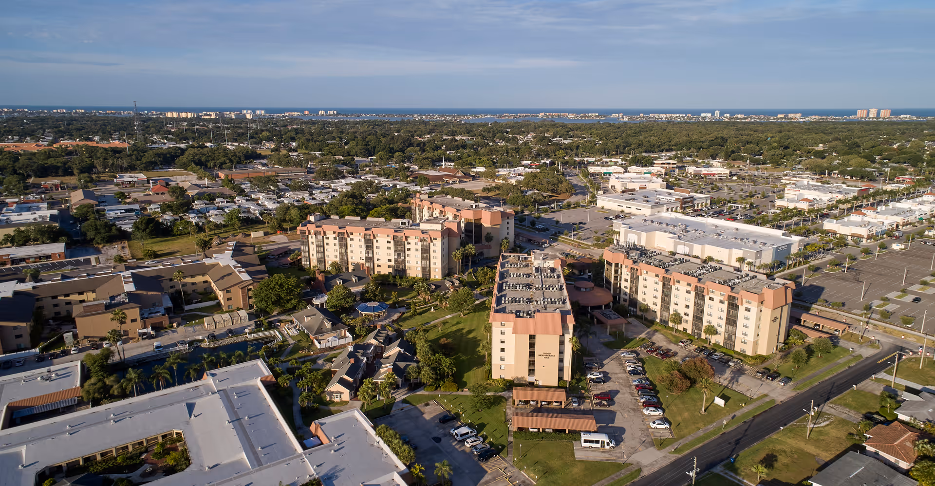 Aerial view of Freedom Square senior living campus with beige buildings and parking.