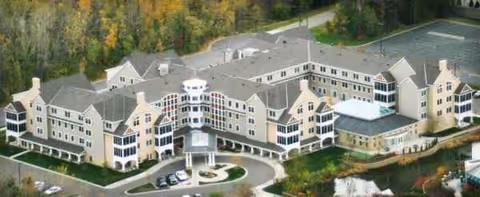 Aerial view of The Commons on Marice senior living campus with interconnected buildings and parking.