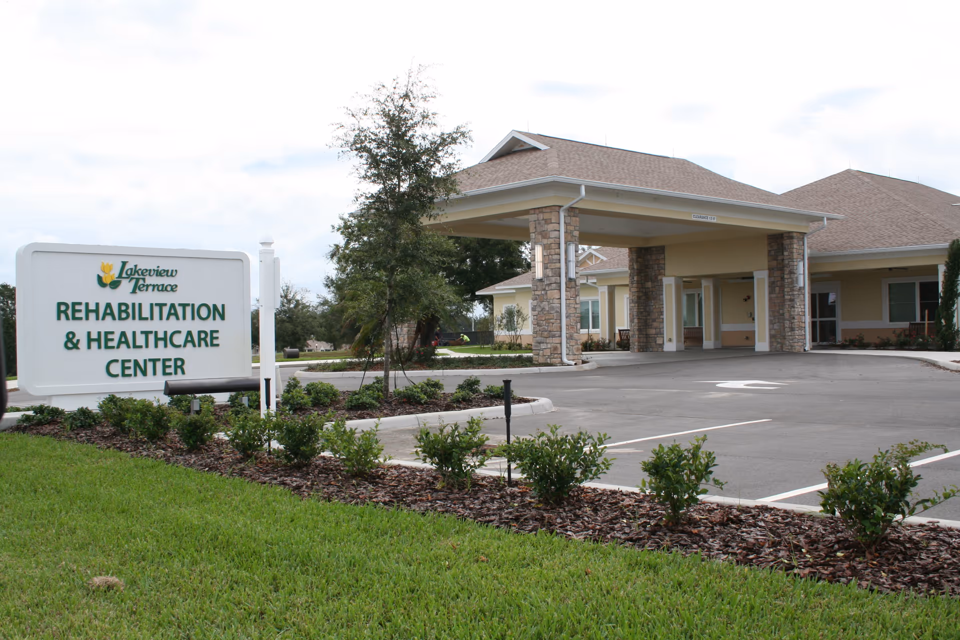 Exterior view of Lakeview Terrace Rehabilitation & Healthcare Center with entrance canopy and sign.