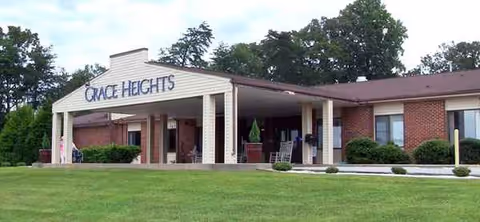 Grace Heights front entrance of a brick senior living facility with a green lawn.