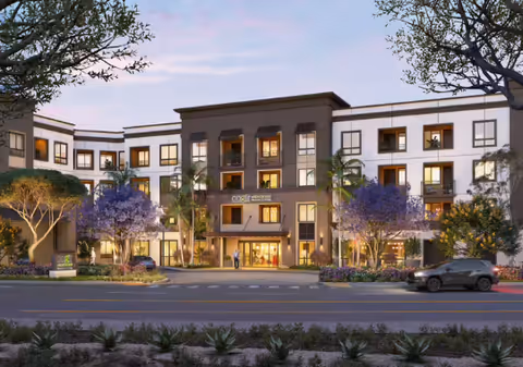 Exterior view of Cogir of South Bay senior living facility with landscaping and palm trees.