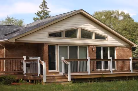 Exterior of Briar Hill Assisted Living with brick facade and wooden front deck.