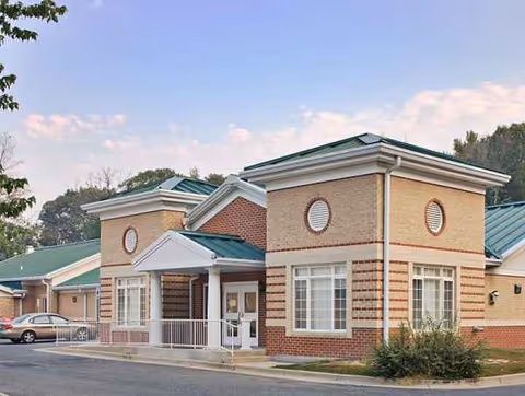 Exterior view of Waldorf Center facility with brick walls, green roof, and entryway.