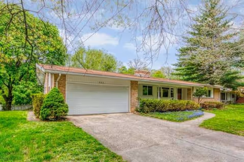 Bright, single-story senior living building with a two-car garage and well-kept lawn.