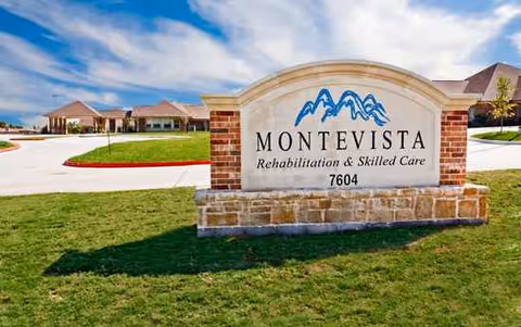 Exterior sign for Montevista Rehabilitation & Skilled Care with a lawn and building in the background.