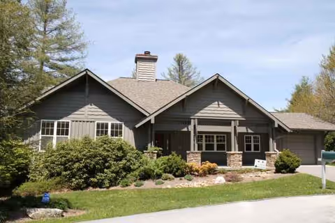 Front view of Chestnut Hill of Highlands facility with a gray exterior and landscaping.