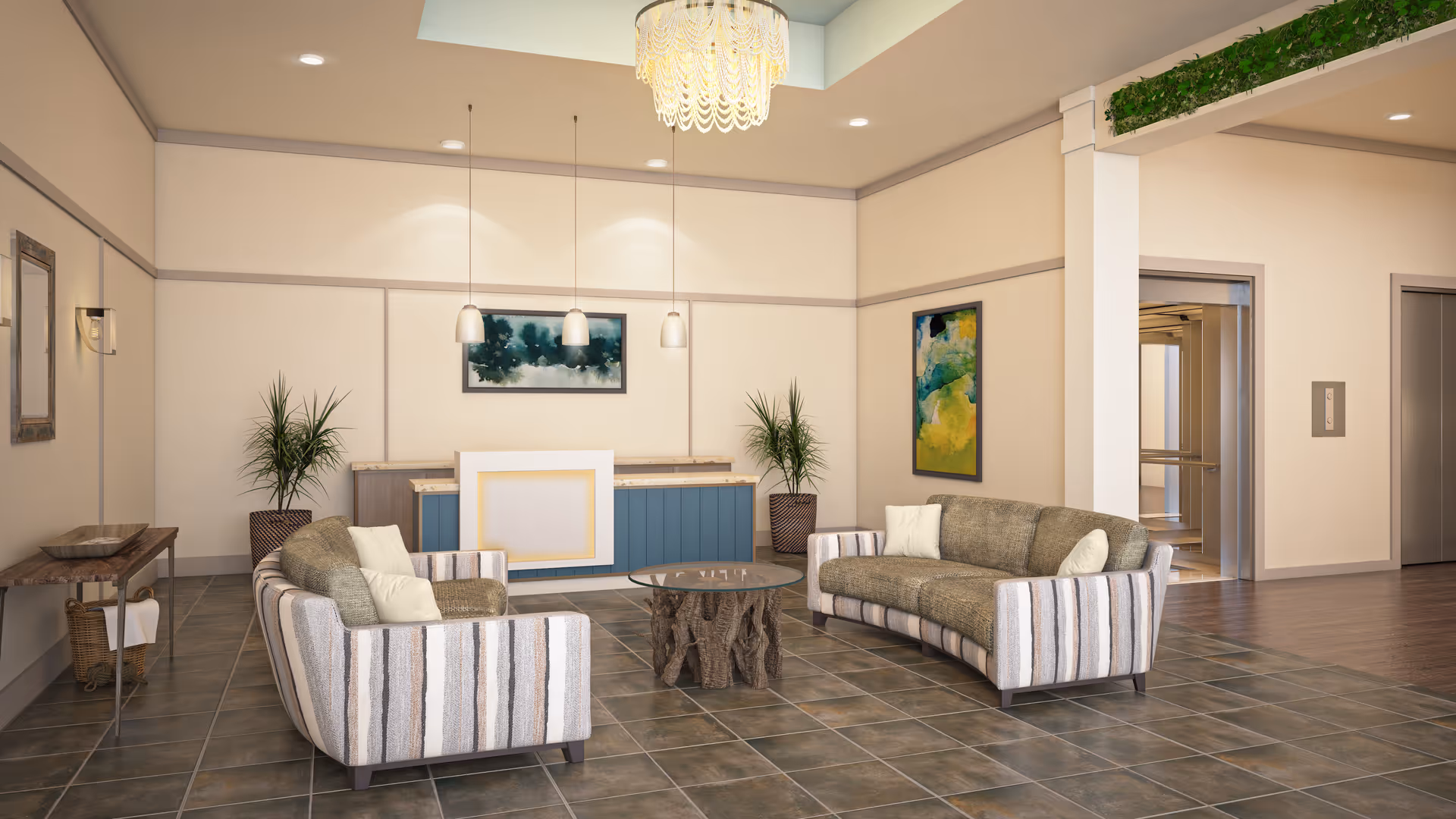 A spacious and well-lit living room area with two striped sofas facing each other around a round wooden coffee table. The room features tiled flooring, a blue and beige reception desk against the back wall, two potted plants, modern pendant lights hanging from the ceiling, and colorful abstract paintings on the walls. There is an elevator and hallway visible in the background.