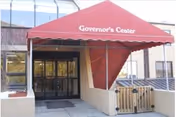 Red awning reading 'Governor's Center' over the glass entrance doors of the building.