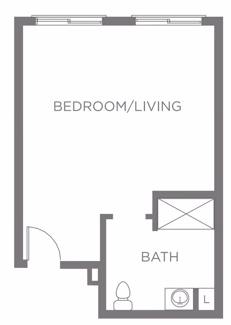 Floor plan layout showing a combined bedroom and living area with an adjacent bathroom that includes a toilet, sink, and shower.