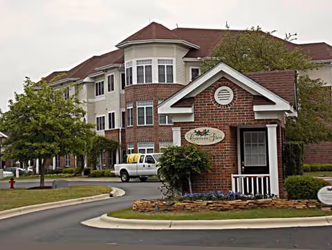 Exterior view of Cypress Glen Retirement Community with brick entrance and landscaping
