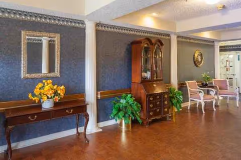 Interior lounge area with vintage furniture, potted plants, and decorative wall accents.