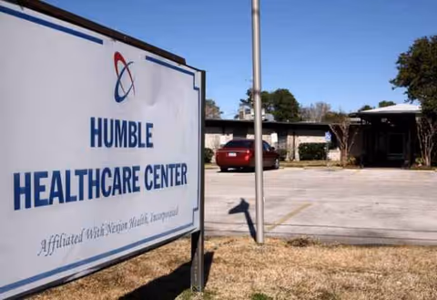 Large sign reads Humble Healthcare Center near a parking lot and building exterior.
